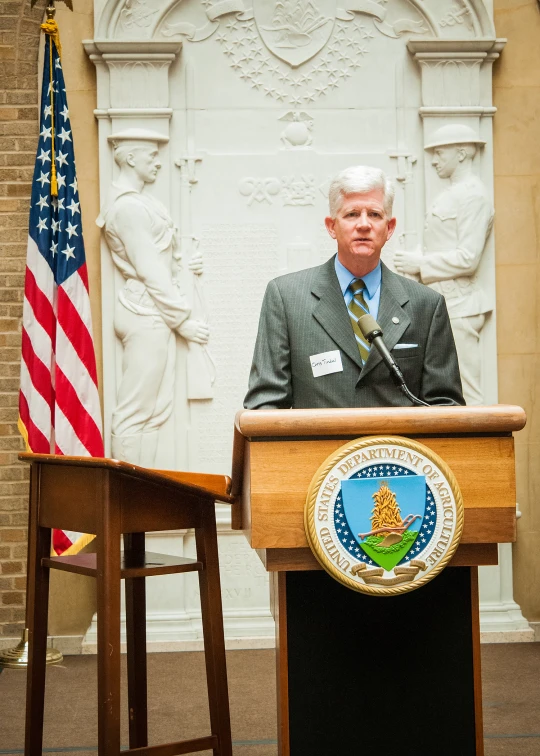 a man that is standing at a podium