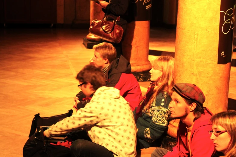 a group of young children sitting in a row