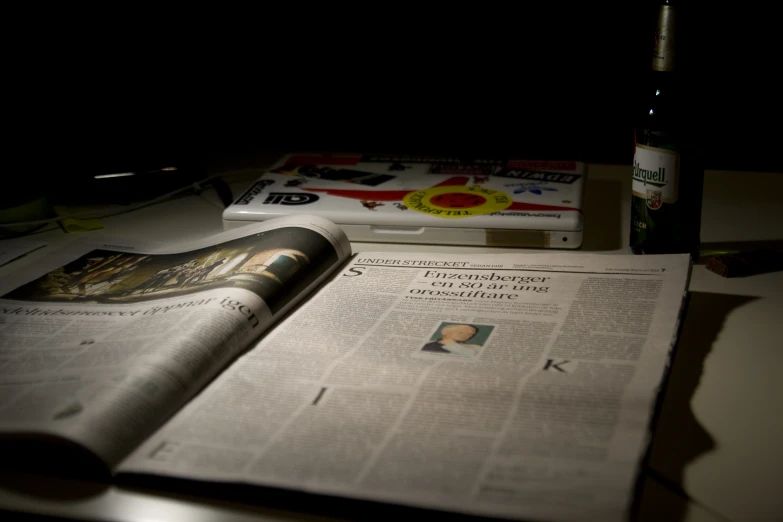 a bottle and some paper on top of a table