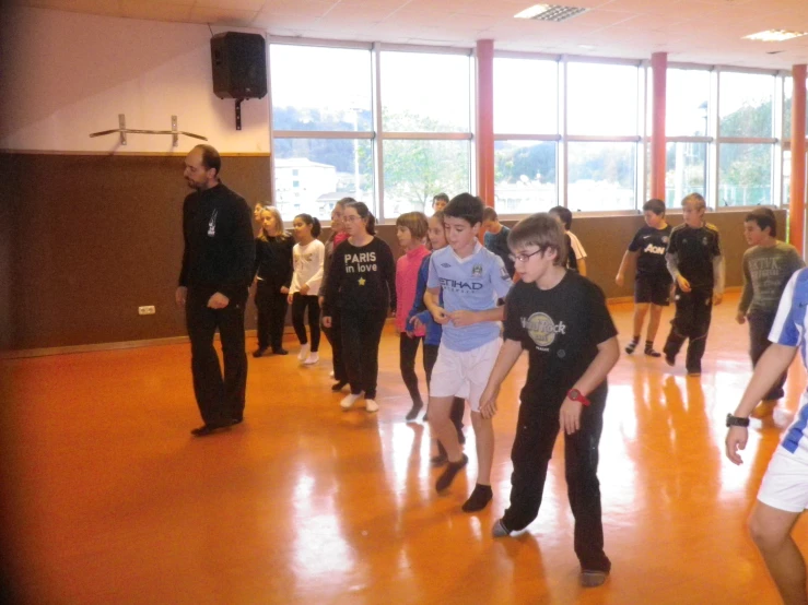 a group of s standing around in a gymnasium