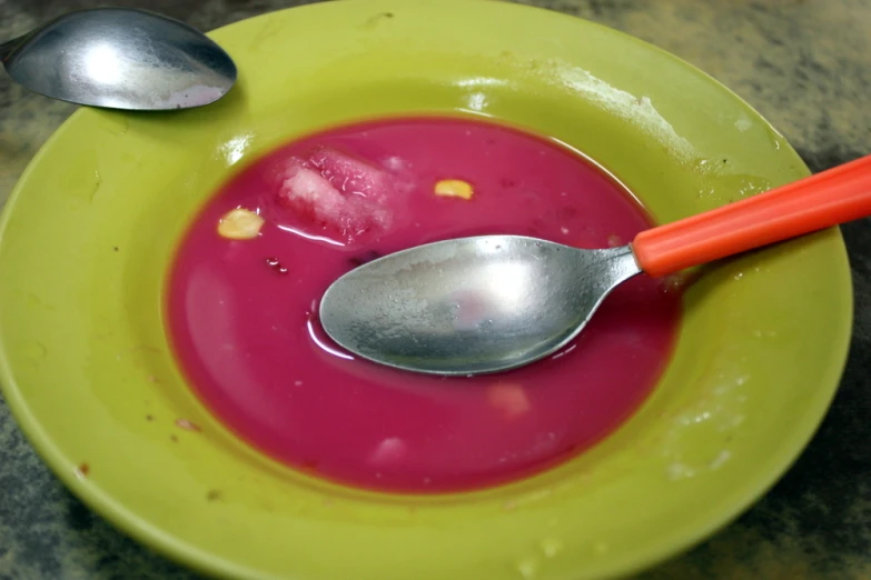 there is a spoon in the bowl on the table