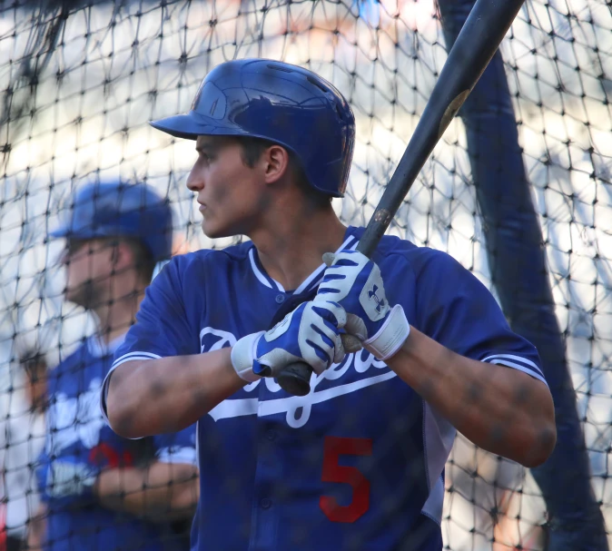 a baseball player is holding his bat ready to swing