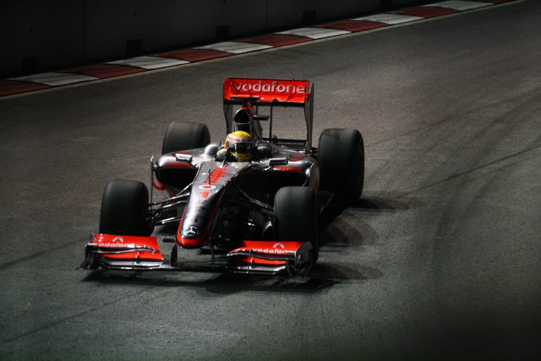 a man driving a race car on top of a road