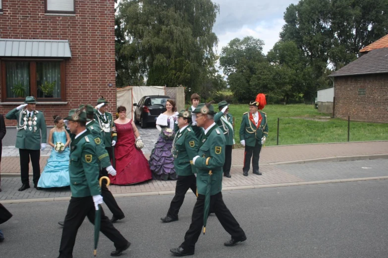 some people dressed in costumes and marching on the street