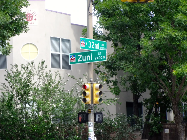 street signs at intersection in urban setting, residential area