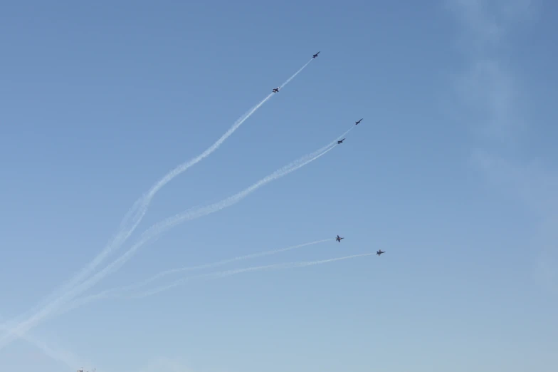 multiple planes flying in formation at an air show