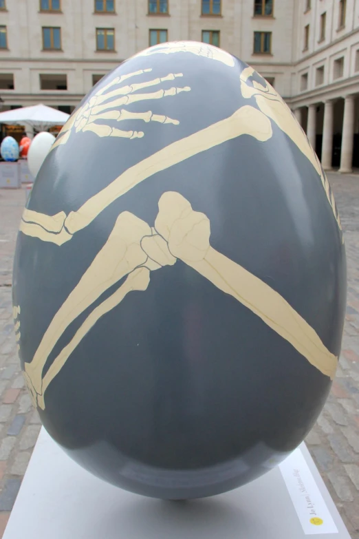 a large black ball with skeleton designs painted on it