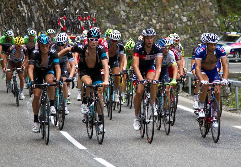 a group of bikers riding down the street