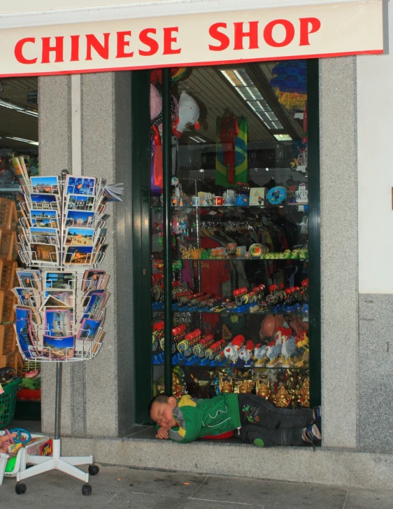 the door to a chinese shop has shelves with decorations