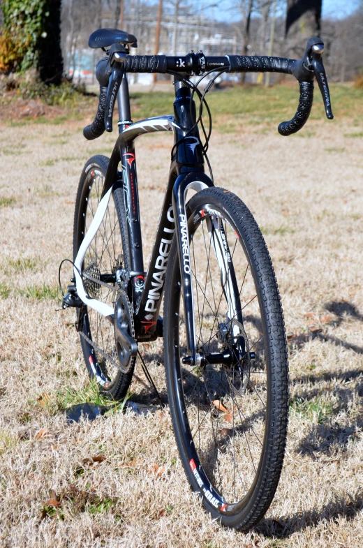 a bicycle parked on the side of a dirt road