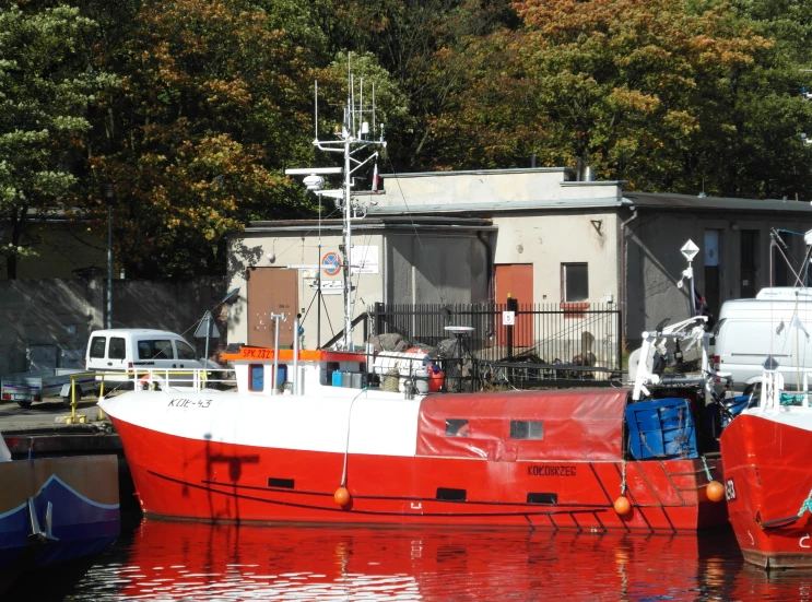 two boats are parked side by side in the water