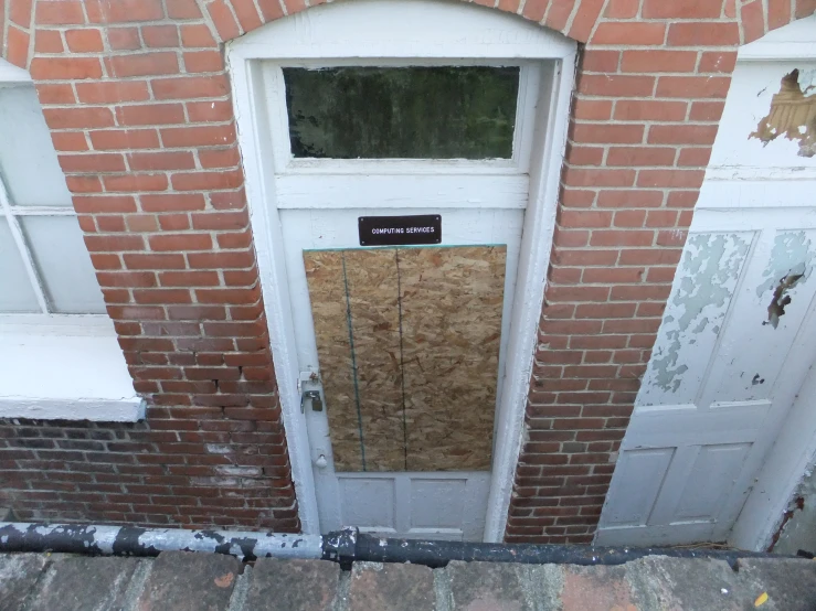 a door is missing a wood paneled door frame