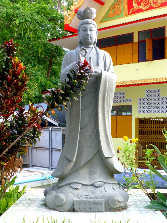 a statue of a man with his hands on a chain