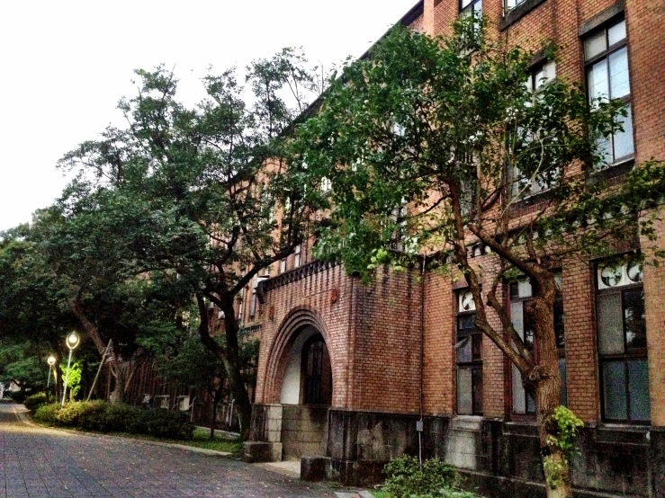 a red brick building with some trees around it