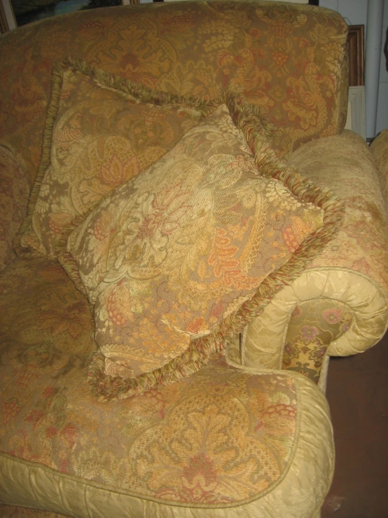a couch with some pillows sitting on top of it