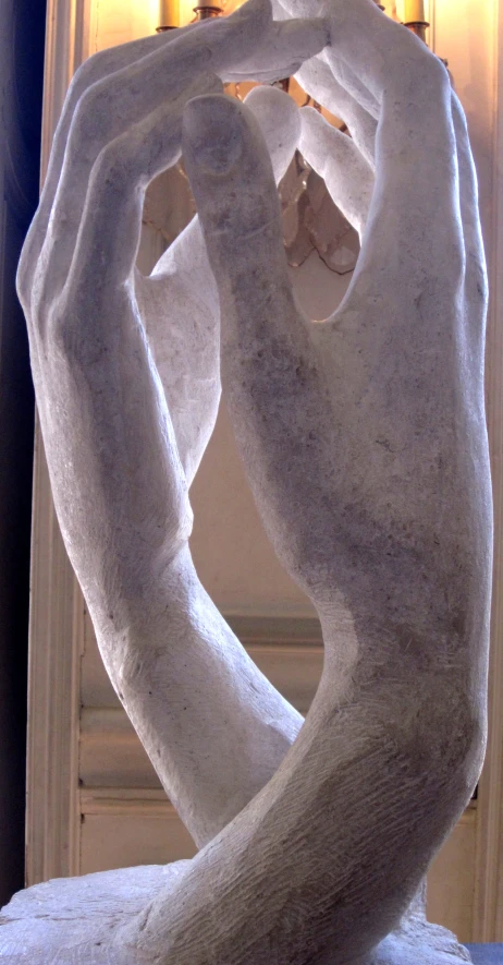 a white sculpture sits by the window