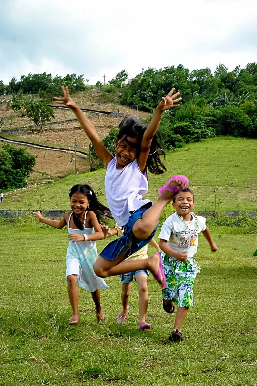 group of children jumping in the air in a field