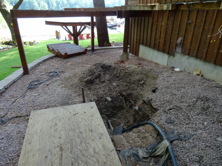 a wooden bench sitting inside of a backyard under a fence