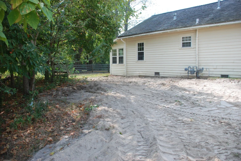 the house in the field is near the trees