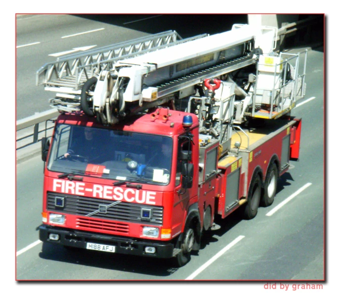 the large fire truck is pulling over a truck on the road