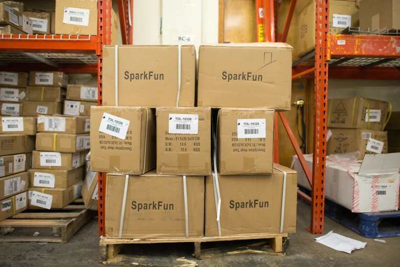 several cardboard boxes stacked on a rack in a warehouse