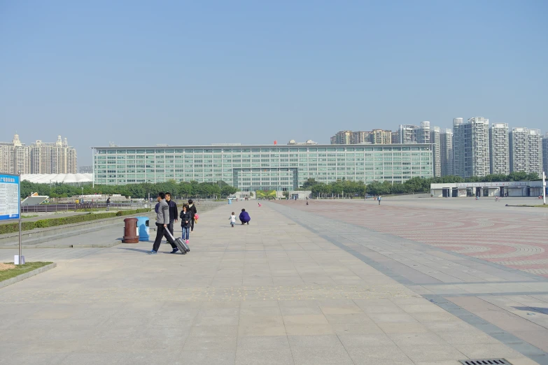 some people walking on a large paved area