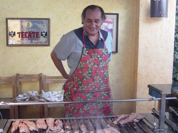 a man wearing an apron with food on it