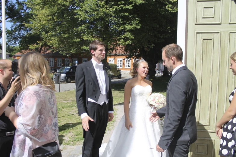 two grooms in tuxedos standing next to each other