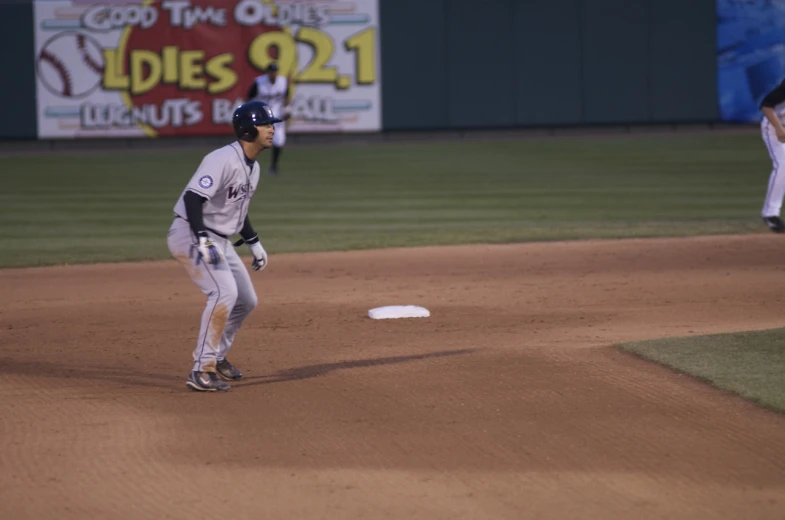 the baseball player is on base trying to catch the ball