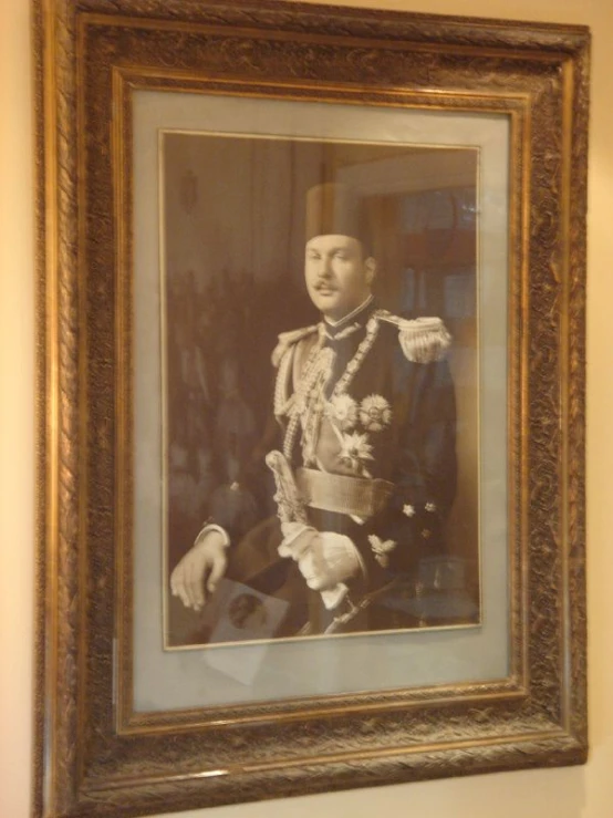 the portrait of an oriental man is framed on the wall