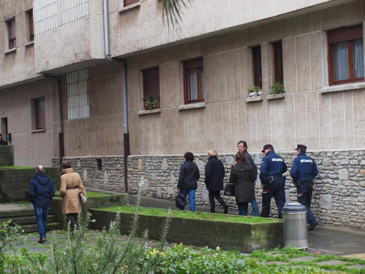 a group of people standing near a building