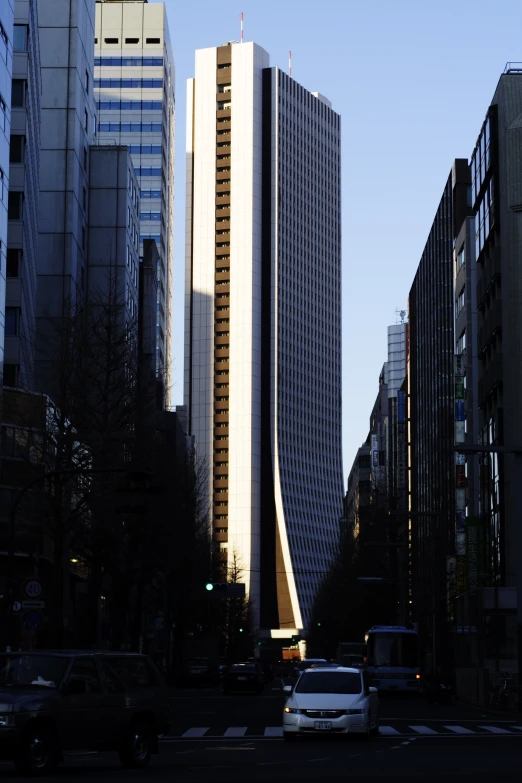 the tall building is across from other buildings in the city