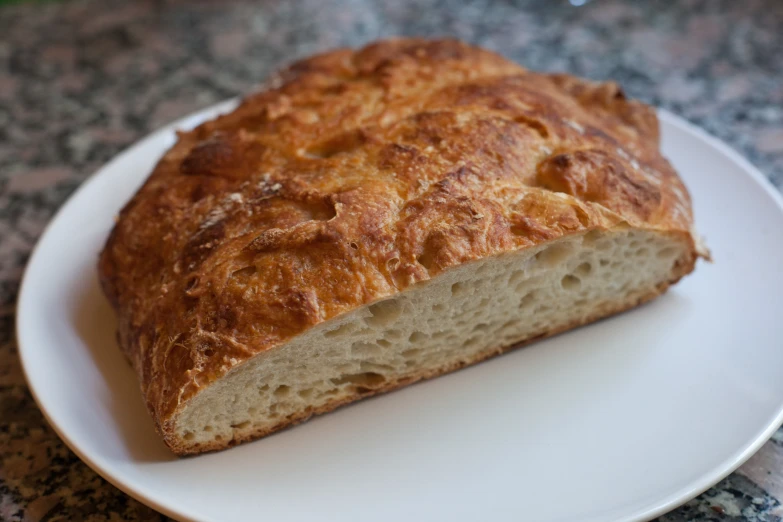 a piece of bread sitting on a white plate