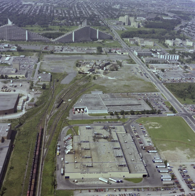 an aerial view shows a lot of old industrial buildings with a large parking lot on both sides