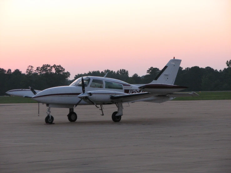 an airplane is parked on the pavement with it's wheels extended