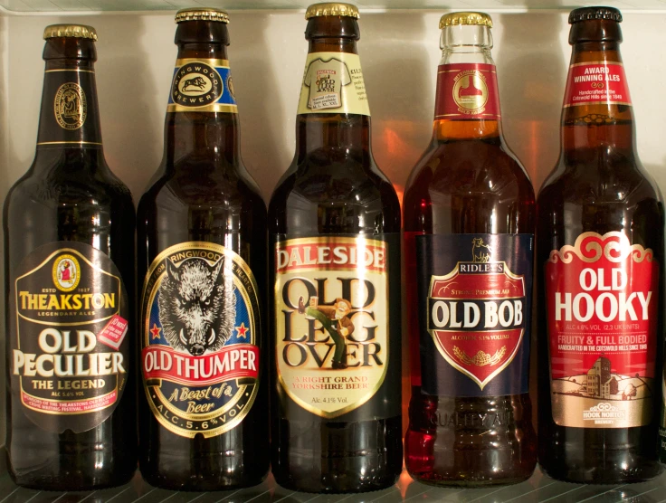 six different varieties of beer are sitting on the shelf