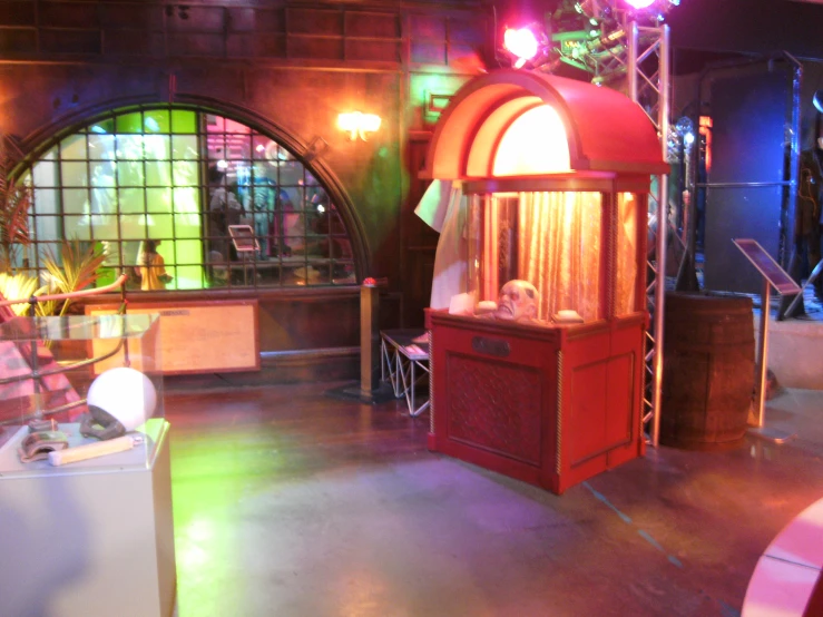 a red and wooden display case sitting in a room