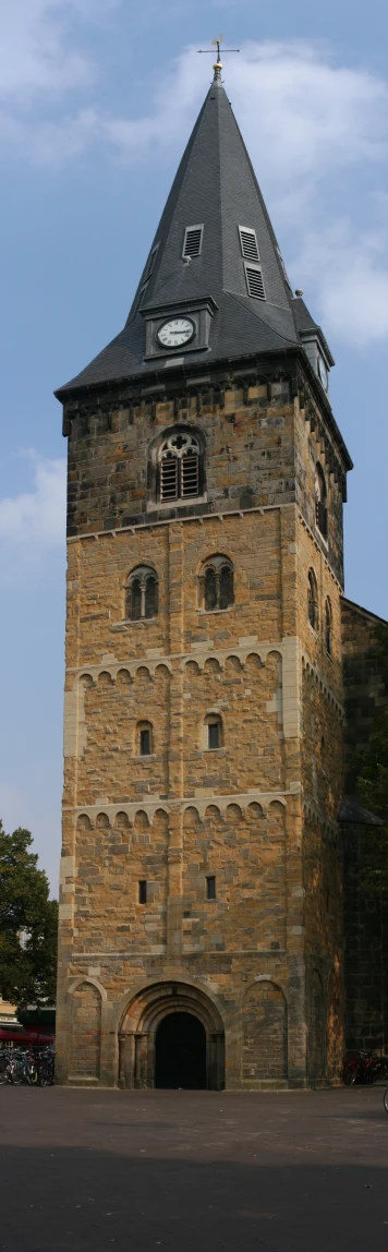 an old stone building with a large window and clock