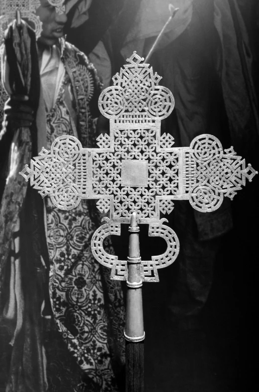 a black and white image of an ornate iron cross