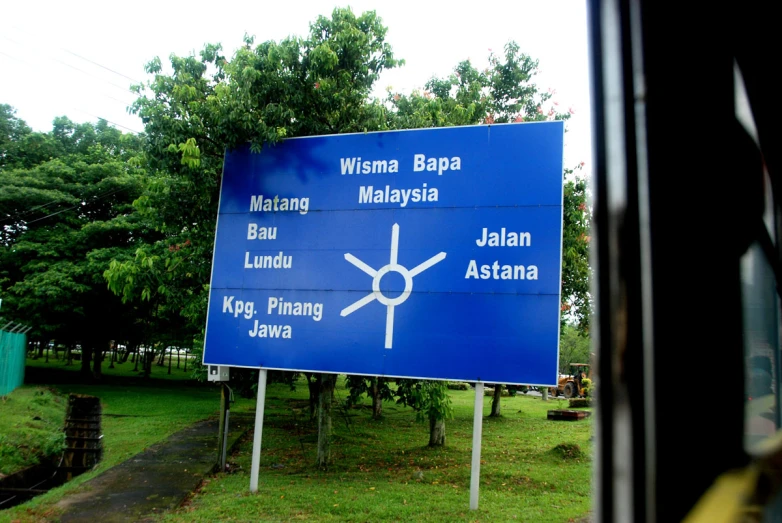 blue road sign with arrows pointing in the direction