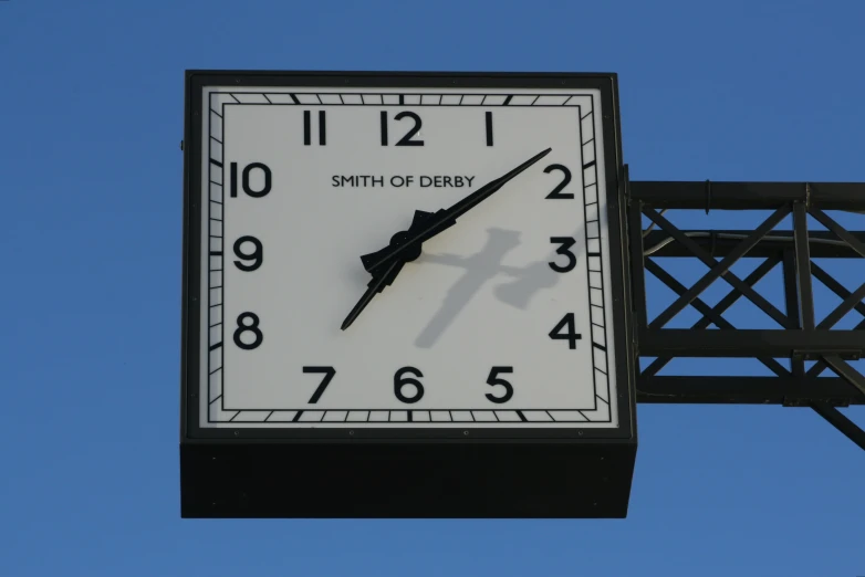 a white and black clock on the side of a building