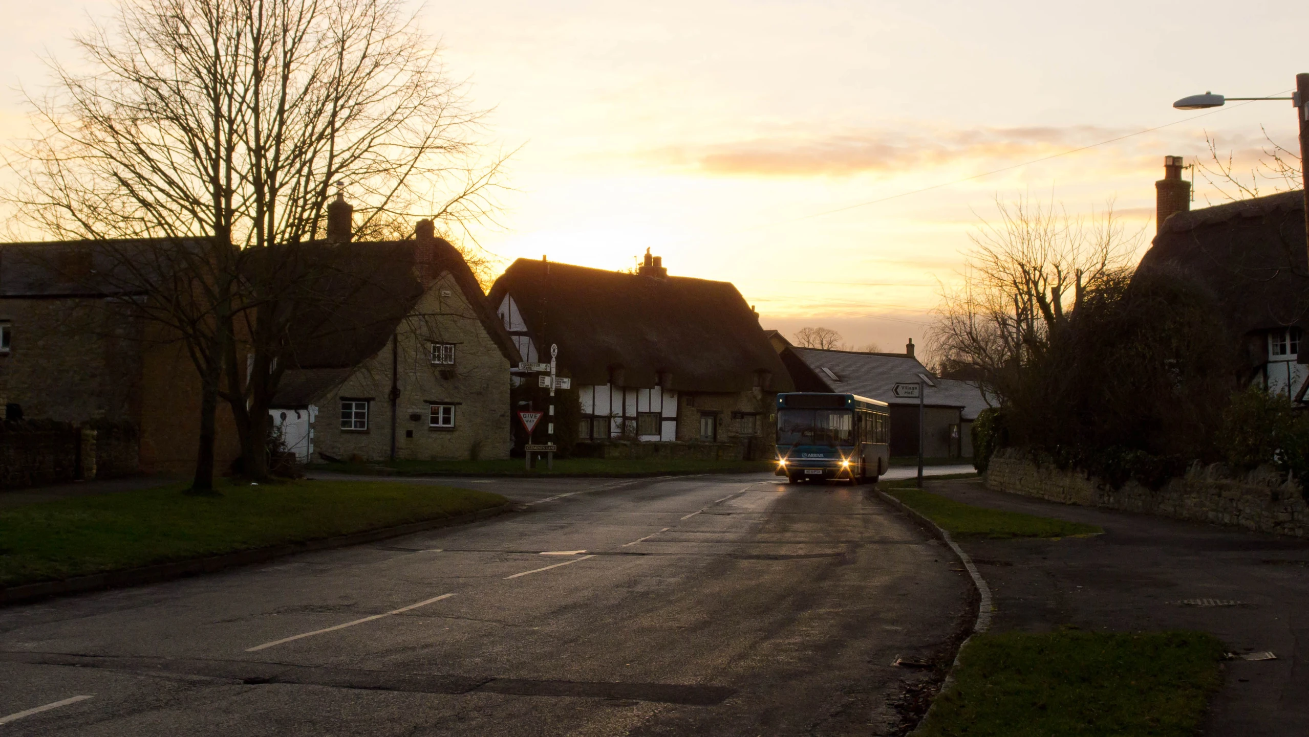 a vehicle driving down a quiet street with many houses