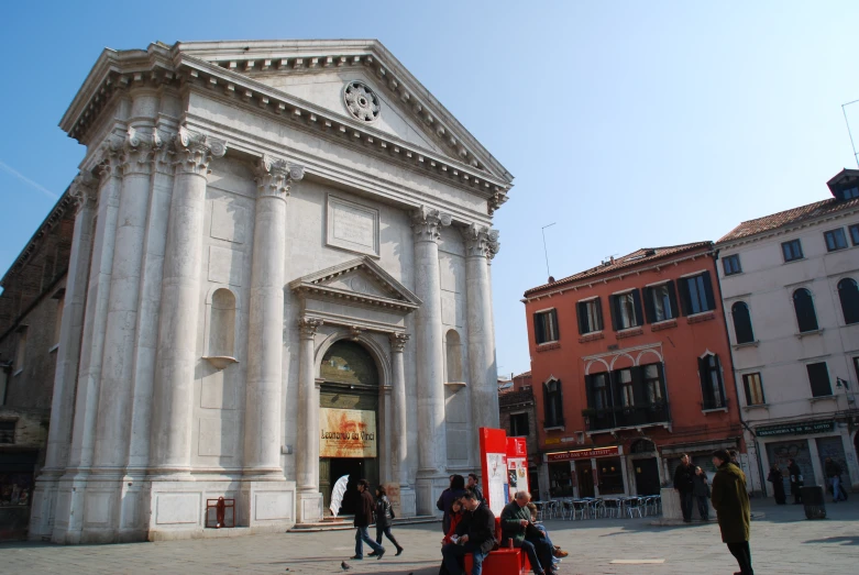 a white and stone building on a city street