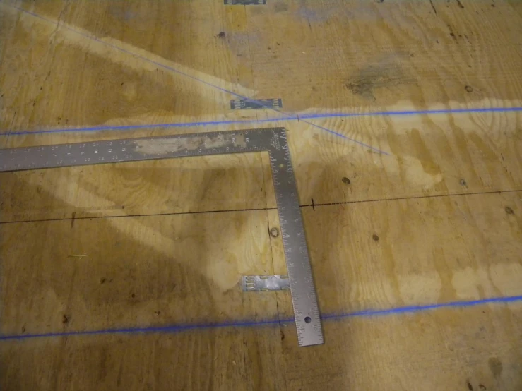 the wooden surface is being worked with measuring tape