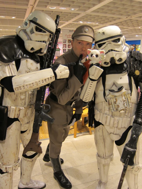 two men dressed in star wars costumes pointing guns at the target target