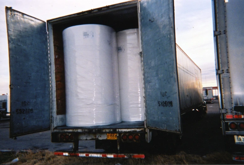 a trailer with three large round objects in the back