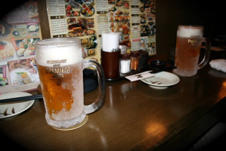 a glass of beer is next to two plates