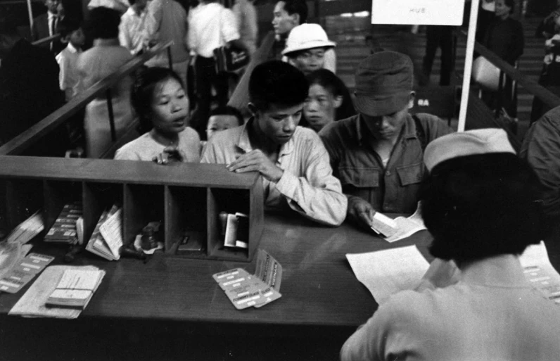 a group of people gathered at a table with cards