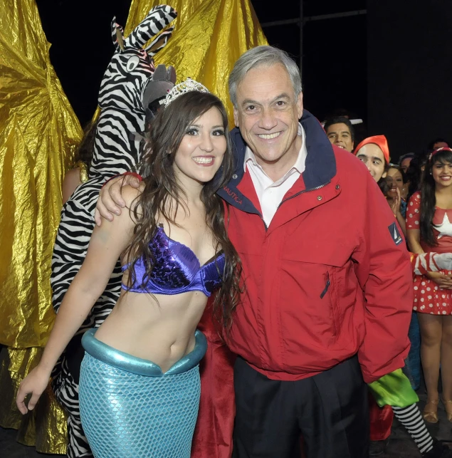 a couple standing next to each other at a costume contest