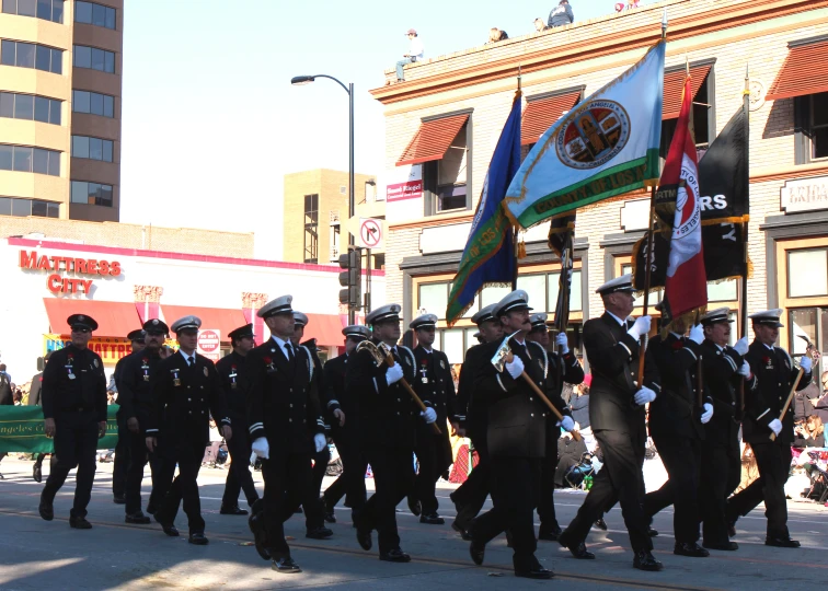 some men walking in a parade and holding flags